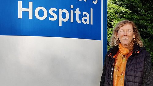 Ellen Nicholson with St Peter's Hospital sign