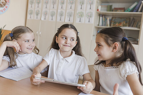 Three children in a classroom
